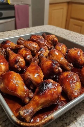 Juicy drumsticks baked in the oven, glazed with sweet and smoky honey BBQ sauce—a family favorite!