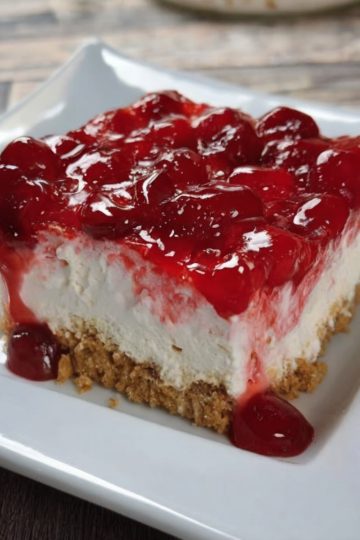 Creamy, easy cheesecake bars with a buttery graham cracker crust and sweet cherry topping. No baking required!