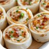 Easy no-bake appetizer made with cream cheese, ranch, cheddar, and bacon wrapped in tortillas and sliced into pinwheels.