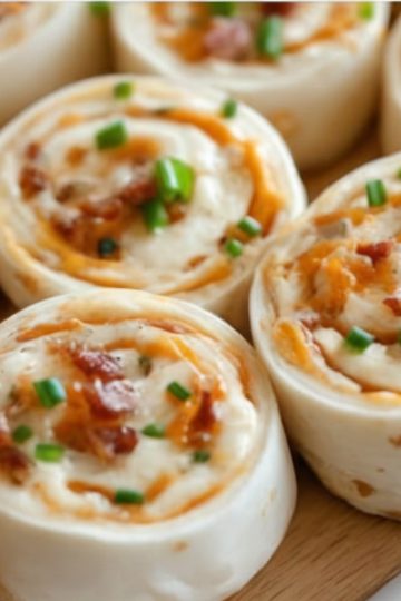 Easy no-bake appetizer made with cream cheese, ranch, cheddar, and bacon wrapped in tortillas and sliced into pinwheels.