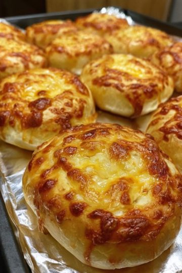 Soft, fluffy rolls topped with crispy golden cheddar cheese, perfect for every meal or snack.