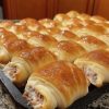 Soft crescent rolls stuffed with creamy sausage filling — a warm, savory treat perfect for any meal.
