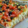 Seven layers of Tex-Mex goodness—beans, crema, salsa, avocado, cheese, and all your favorite toppings!