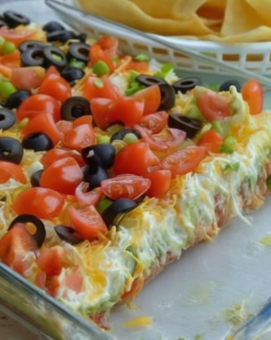 Seven layers of Tex-Mex goodness—beans, crema, salsa, avocado, cheese, and all your favorite toppings!