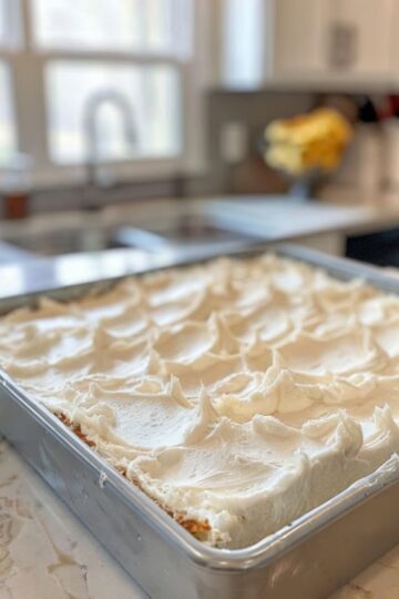 [wprm-recipe id="cream-cheese-cake" name="Cream Cheese Cake" servings="12" prep_time="15" cook_time="60" total_time="75" course="Dessert" cuisine="American" keywords="cream cheese cake recipe, moist cake recipe, easy cream cheese dessert"] [wprm-ingredients] * 1 (8 oz) block cream cheese, softened * 1/2 cup unsalted butter, softened * 1 1/2 cups granulated sugar * 3 large eggs * 1 tsp vanilla extract * 1 1/2 cups all-purpose flour * 1 1/2 tsp baking powder * 1/4 tsp salt * 1/2 cup sour cream or Greek yogurt Optional Flavor Twists: * Zest of 1 lemon + 1 tbsp lemon juice * 1/4 cup cocoa powder (replace part of flour for chocolate version) * 1/2 cup berry jam swirl [/wprm-ingredients] [wprm-instructions] 1. Preheat oven to 325°F (165°C). Grease a 9-inch round or square pan. 2. Beat cream cheese, butter, and sugar until light and fluffy. 3. Add eggs one at a time, then vanilla extract. 4. Whisk flour, baking powder, and salt. Alternately add dry ingredients and sour cream to batter. 5. Pour batter into pan and bake for 50-60 minutes, until golden and toothpick comes out clean. 6. Cool for 1 hour before slicing. Top as desired. [/wprm-instructions] [wprm-notes] * Brush warm cake with simple syrup for extra moisture. * Substitute cocoa powder for flour to make chocolate version. * Store covered at room temperature for 2 days or freeze for 1 month. [/wprm-notes] [/wprm-recipe]