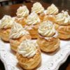 Light, airy choux pastry shells filled with silky vanilla pudding whipped cream. This bakery-style dessert is easy to make and impossible to resist!