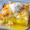 Tangy lemon and rich cream cheese layered under a golden buttery topping—an easy dessert that tastes like sunshine.