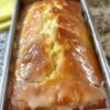 A buttery, moist lemon loaf infused with zesty flavor and topped with a sweet, crunchy citrus glaze.