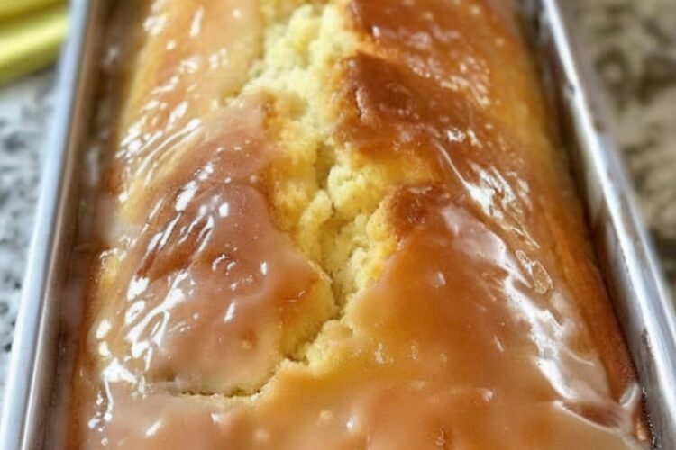 A buttery, moist lemon loaf infused with zesty flavor and topped with a sweet, crunchy citrus glaze.