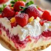 A cool, creamy, fruity dessert layered with strawberries, pineapple, bananas, and whipped topping over a buttery graham crust — the perfect no-bake summer treat.