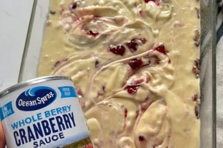 A festive holiday cake with a buttery pecan base, tender vanilla crumb, and joyful cranberry–cream cheese swirls.