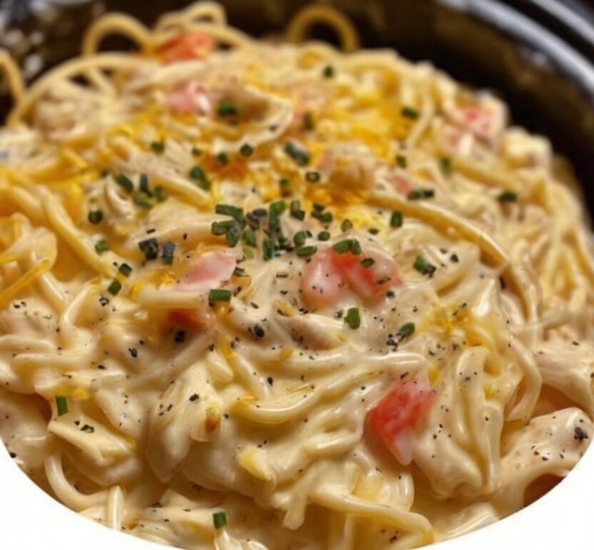 A comforting slow cooker dinner made with tender shredded chicken, creamy sauce, and spaghetti cooked right in the crockpot for maximum flavor and minimal effort.