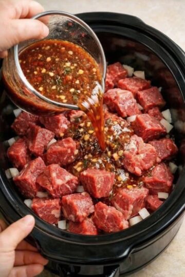 The ultimate dump-and-go comfort food: chuck roast, potatoes, onions, beef broth, and onion soup mix transform into fall-apart tender beef stew with rich, savory broth. No browning, no babysitting—just layer, pour, and let time work its magic.