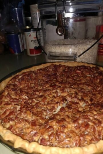 Pecan Pie with Secret Cream Cheese Layer The pecan pie that changes everything: a hidden layer of tangy, silky cream cheese beneath the classic sweet, crunchy pecan topping. The cream cheese balances the sweetness and adds incredible richness that makes this pie unforgettable. Your new signature dessert. Equipment: 9-inch pie pan, 2 medium mixing bowls, electric mixer or whisk, rubber spatula, measuring cups and spoons, wire cooling rack Prep Time: 20 minutes Bake Time: 45-55 minutes Cool Time: 2-3 hours Total Time: 4 hours Yields: 8-10 slices Ingredients: For the Cream Cheese Base: 8 oz cream cheese, softened ⅓ cup granulated sugar ¼ teaspoon salt 1 teaspoon vanilla extract For the Pecan Topping: 3 large eggs 1 cup light corn syrup 1 cup packed light brown sugar ¼ cup unsalted butter, melted 1 teaspoon vanilla extract 1½ cups pecan halves For the Crust: 1 (9-inch) unbaked pie crust Instructions: Preheat oven to 350°F (175°C). Place pie crust in 9-inch pie pan. In medium bowl, beat softened cream cheese with electric mixer or whisk until smooth and creamy with no lumps. Add sugar and salt, beating until completely combined and fluffy. Stir in vanilla until well mixed. Using rubber spatula, spread cream cheese mixture evenly across bottom of unbaked pie crust, creating smooth, uniform layer covering entire bottom and reaching edges. In another medium bowl, whisk eggs until well beaten and slightly frothy. Add corn syrup, brown sugar, melted butter, and vanilla. Whisk vigorously until completely smooth, sugar dissolved, and well combined. Should be glossy and pourable. Gently stir pecan halves into syrup mixture, coating every pecan evenly. Carefully pour pecan mixture over cream cheese layer. Work slowly to avoid disturbing cream cheese base. Use fork to arrange pecans evenly across top for beautiful presentation. Place pie on baking sheet. Bake 45-55 minutes until filling is set around edges and center has slight jiggle. Knife inserted near center should come out mostly clean. Pecans should be deeply toasted. Cover crust edges with foil after 30 minutes to prevent over-browning. Cool completely on wire rack for at least 2-3 hours, or refrigerate 4-6 hours or overnight. Cream cheese layer needs time to set and filling needs to firm up. Slice and serve at room temperature or chilled. Top with whipped cream or vanilla ice cream if desired. Notes: Cream cheese must be completely softened—room temperature for 1 hour or microwave 10-15 seconds. Cold won't spread smoothly and creates lumps. Must cool completely for clean slices and proper texture. Cutting while warm = runny mess. Patience crucial. Use pie shield or cover crust edges with foil after 30 minutes to prevent over-browning. Room temperature eggs mix more smoothly into filling for uniform texture. Take moment to arrange pecans beautifully—this pie is a showstopper. Delicious at room temp or chilled. Chilled makes cream cheese layer more prominent. Add bourbon: Stir 2 tablespoons bourbon into pecan filling for Southern depth. Try maple: Replace half corn syrup with pure maple syrup for complex sweetness. Make it chocolate: Add ½ cup chocolate chips to pecan mixture for turtle pie. Orange zest: Stir 1 tablespoon orange zest into cream cheese layer for brightness. Dark brown sugar creates deeper, more molasses-forward flavor. Toast pecans first to intensify nutty flavor. Mini pies: Use muffin tin with pie crust rounds. Reduce baking time to 25-30 minutes. Add espresso: Mix ½ teaspoon instant espresso powder into filling for coffee notes. Different crust: Graham cracker or shortbread crust both work beautifully. Cream cheese layer mixed with filling: Cream cheese not spread evenly or poured too aggressively. Spread smooth and even, pour gently. Without corn syrup: Substitute golden syrup or combo of maple syrup and honey. Texture slightly different. Done when: Edges set and puffed, center has slight jiggle, knife near center comes out mostly clean. Chopped pecans: Can use but halves create classic, beautiful top. Chopped works but less impressive. Must refrigerate due to cream cheese layer. Store covered in fridge. Cover and refrigerate up to 5 days. Actually improves after day or two as flavors meld. Freezes beautifully. Wrap tightly in plastic then foil up to 2 months. Thaw overnight in fridge. Ideal make-ahead. Bake 2-3 days before serving and refrigerate. Flavors develop with time. Serve: Room temp or chilled with whipped cream, vanilla ice cream, or caramel drizzle. For cleanest slices, dip knife in hot water and wipe between cuts. Pairs with: Strong black coffee, bourbon, sweet dessert wine like Sauternes.