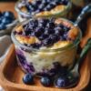 Protein-packed baked oatmeal jars bursting with juicy blueberries and warm spices. With 47g of protein per serving, these grab-and-go breakfasts are perfect for meal prep and taste like dessert for breakfast. Naturally sweetened, gluten-free adaptable, and ready in under 40 minutes.