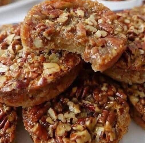 Classic Southern cookies with rich butter flavor and toasted pecans. Butter and sugar creamed until fluffy, mixed with vanilla, flour, salt, and finely chopped pecans, then rolled into balls and baked until edges are golden. The signature crumbly, shortbread-like texture melts in your mouth. Optional powdered sugar dusting adds a snowy finish.