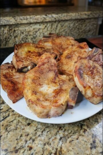 Tender bone-in pork chops seared until golden, then coated in a sweet-tangy glaze of mayonnaise, Dijon mustard, and honey, and baked until perfectly cooked. The mayonnaise keeps them incredibly moist while creating a caramelized coating under the broiler. Restaurant-quality results in under an hour with minimal ingredients.