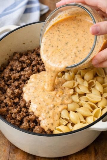 The ultimate one-pot comfort dinner: ground beef browned with onions and garlic, then uncooked pasta shells and a creamy tomato sauce poured right on top. Everything simmers together until the pasta is tender and coated in velvety, cheesy sauce. Ready in 35 minutes with minimal cleanup.