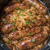 Irish-style comfort food: plump pork sausages slow-cooked over caramelized onions in rich beef stock and Worcestershire sauce. The onions melt into sweet, jammy silk and naturally thicken the gravy without flour. Set it in the morning, come home to incredible aromas. Perfect over mashed potatoes or with crusty bread.