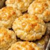 Classic Southern comfort: fluffy, buttery biscuits made without rolling or cutting. Just mix flour, baking powder, cold butter, and buttermilk into shaggy dough, drop spoonfuls onto a baking sheet, and bake until golden. Crispy edges, tender centers, rustic appearance. Ready in under 30 minutes. Perfect with sausage gravy or fried chicken.