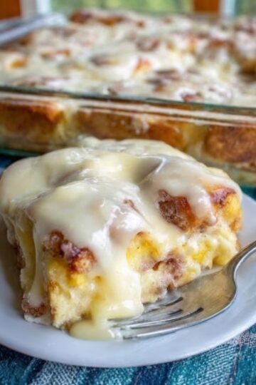 The ultimate make-ahead breakfast: refrigerated orange rolls cut into quarters, soaked overnight in a custard of eggs, cream, brown sugar, fresh orange juice and zest, then baked until golden with soft, custardy centers. Topped with homemade orange icing. All the flavor of homemade sweet rolls with 5 minutes of prep the night before.