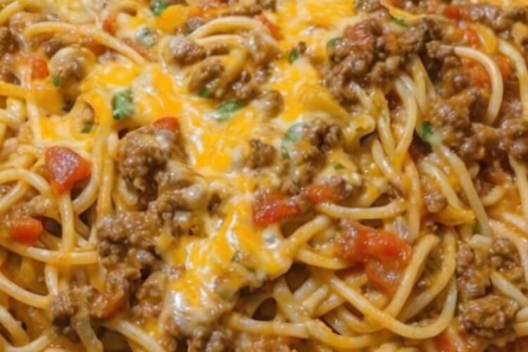 A cheesy, creamy baked pasta dish combining taco-seasoned beef and spaghetti for a comforting and easy family dinner.
