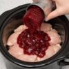 A sweet and savory slow cooker chicken dish made with cranberry sauce, creating a rich, glossy glaze perfect for easy dinners or holiday meals.