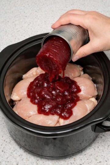 A sweet and savory slow cooker chicken dish made with cranberry sauce, creating a rich, glossy glaze perfect for easy dinners or holiday meals.