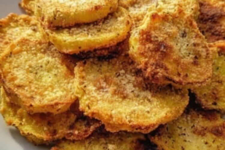 Crispy, golden squash rounds without deep-frying. Yellow squash or zucchini slices are dipped in buttermilk, coated in seasoned cornmeal and flour mixture, arranged on a baking sheet, sprayed with oil, and baked at high heat until crispy. Flipped halfway through for even browning. The cornmeal creates classic Southern-fried texture while baking keeps it lighter.