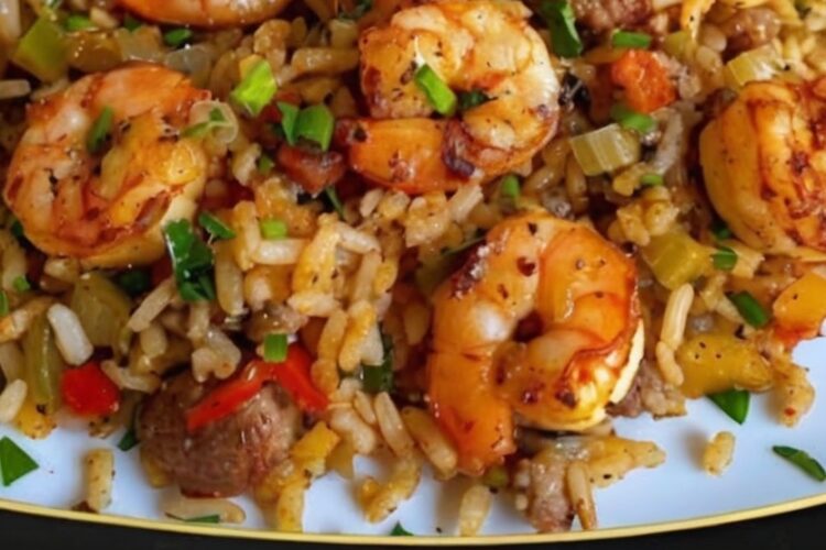 A hearty, one-pan rice dish loaded with seasoned meat, tender shrimp, and bold Cajun spices, perfect for a comforting family meal.