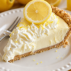 A creamy no-bake lemon cheesecake-style pie with graham cracker crust. Perfect refreshing summer dessert for parties, potlucks, and holiday gatherings.