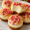 Mini no-bake cheesecake bites with buttery graham crust and strawberry crunch topping. Perfect bite-sized party dessert.