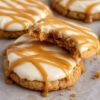 Soft cinnamon graham cracker cookies topped with tangy cream cheese frosting and salted caramel drizzle. A bakery-style dessert perfect for holidays or special treats.
