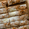 Soft and chewy German honey spice bars with cinnamon, cloves, nutmeg, toasted nuts, and a sweet vanilla glaze. Perfect for Christmas baking and holiday gifting.