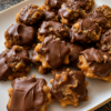 No-bake caramel pecan chocolate candy clusters with crispy rice cereal and glossy semi-sweet coating. Perfect holiday homemade candy recipe.