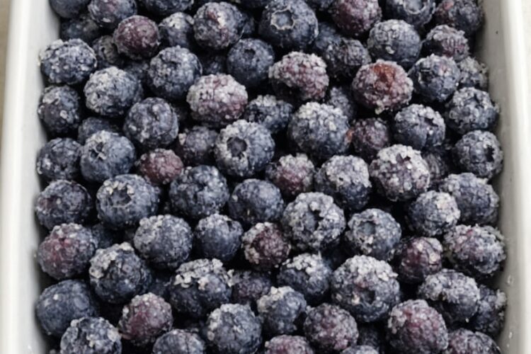 An effortless cobbler-style dessert made with frozen blueberries, sugar, cake mix, and butter. No mixing required — just dump and bake.