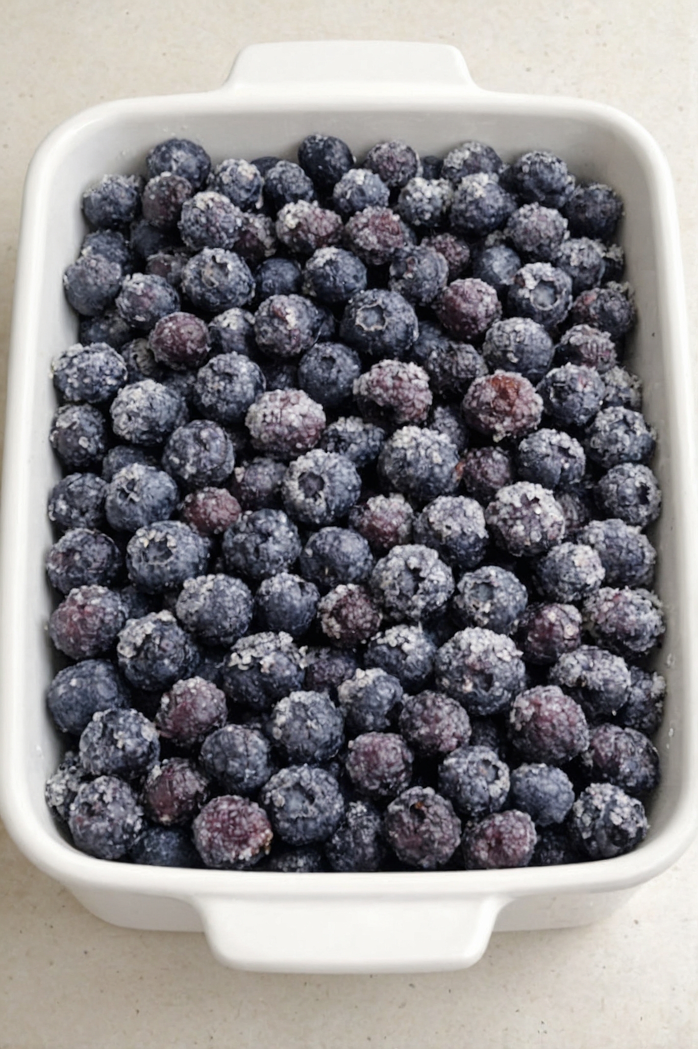 An effortless cobbler-style dessert made with frozen blueberries, sugar, cake mix, and butter. No mixing required — just dump and bake.