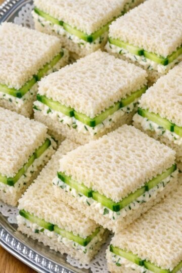 A refreshing Southern classic made with thin cucumber slices, creamy spread, and soft white bread. Perfect for tea parties, showers, and light lunches.