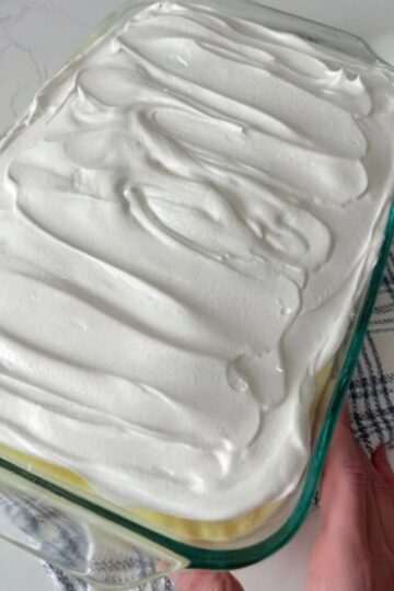 A creamy, nostalgic layered dessert featuring banana cake, crushed pineapple, sweet cream cheese pudding filling, and whipped topping. Perfect for church gatherings, holiday potlucks, and make-ahead entertaining.