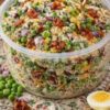 A creamy, sweet and savory cold salad made with frozen peas, crispy bacon, cheddar cheese, and tangy dressing. Perfect for potlucks, barbecues, and holiday gatherings.