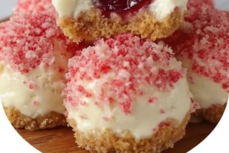 Mini strawberry cheesecake bites with buttery vanilla wafer crust, creamy strawberry filling, and crunchy pink crumble topping. Perfect for parties and summer gatherings