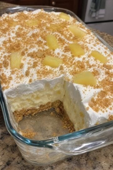 This No-Bake Pineapple Cream Dessert combines a buttery graham cracker crust with a creamy pineapple cheesecake filling and fluffy whipped topping for an easy make-ahead dessert everyone loves. Perfect for summer parties, family gatherings, potlucks, holiday celebrations, and backyard cookouts, this refreshing no-bake pineapple dessert delivers tropical flavor with minimal effort and no oven required.