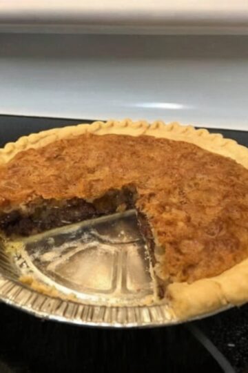 A classic Kentucky-style Derby Pie featuring a flaky buttery crust filled with rich chocolate chips, toasted pecans, vanilla, and a gooey brownie-like filling. Perfect for holidays, Derby parties, potlucks, Sunday dinners, and chocolate lovers.
