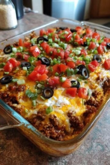 A cheesy keto taco casserole loaded with seasoned ground beef, cream cheese, sour cream, cheddar, and mozzarella. High in protein, low in carbs, and perfect for meal prep, weight loss goals, and easy family dinners.