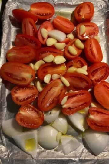 A rich homemade roasted tomato sauce made with fresh Roma tomatoes, roasted garlic, onions, basil, and olive oil. Perfect for pasta, pizza, lasagna, chicken, meal prep, and freezer-friendly family dinners.