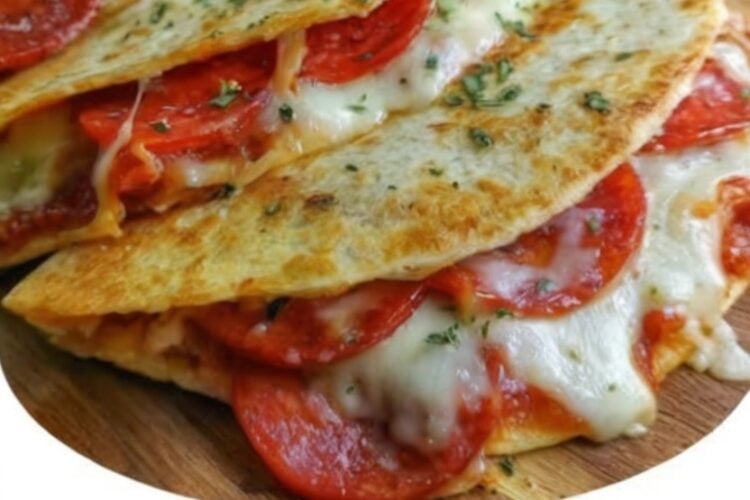 These Pepperoni Pizza Quesadillas combine crispy golden tortillas with gooey mozzarella cheese, savory pepperoni, sautéed onions and peppers, and Italian seasoning. Ready in just 20 minutes, they're an easy family dinner or fun lunch that's perfect with warm pizza sauce for dipping.