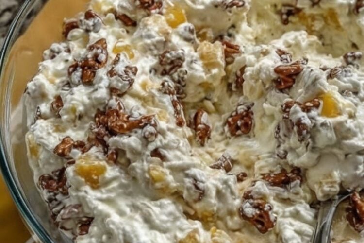 Paste the fields below straight into the WP Recipe Maker editor. Headings map to the standard recipe-card fields; the ingredient and instruction blocks go into their matching repeaters. Recipe Name: Pineapple Crackle Salad Summary: A sweet-and-salty potluck dessert that pairs cloud-like cream cheese fluff and tart pineapple with a candied pretzel "crackle" that stays crunchy. Make the base ahead and fold in the pretzels right before serving. Course: Dessert, Side Dish Cuisine: American Keyword: pineapple crackle salad, pretzel salad, pineapple fluff Prep Time: 20 minutes Cook Time: 10 minutes Chill Time: 1 hour Total Time: 1 hour 30 minutes Servings: 12 servings Calories: ~340 kcal per serving (estimate) Author: [Your name] Ingredients Candied Pretzel Crackle 2 cups mini pretzels, coarsely crushed (about 4 oz) 6 tbsp unsalted butter, melted ⅓ cup light brown sugar, packed Creamy Base 16 oz full-fat cream cheese (2 blocks), softened to room temperature ¾ cup granulated sugar 1 tsp pure vanilla extract 8 oz stabilized whipped topping, thawed 20 oz canned pineapple chunks or tidbits, very well drained (or 2 cups fresh pineapple, finely chopped and drained) Instructions Bake the crackle. Preheat oven to 350°F (175°C) and line a rimmed baking sheet with parchment. Toss crushed pretzels with melted butter and brown sugar until evenly coated, then spread in a single layer. Bake 8–10 minutes, stirring once, until the sugar is bubbling. Cool completely on the pan—the coating hardens as it cools—then break up any large clumps. Whip the base. In a large bowl, beat the softened cream cheese, granulated sugar, and vanilla with a hand mixer until completely smooth, about 2 minutes, scraping down the bowl as needed. Fold in the topping. Add the whipped topping and gently fold it in with a rubber spatula until just combined—fold, don't stir, to keep it airy. Add the pineapple. Gently fold in the well-drained pineapple until evenly distributed. Chill. Cover and refrigerate the base at least 1 hour (or up to 2 days). Keep the candied pretzels separate at room temperature. Assemble at serving. Just before serving, fold in about two-thirds of the candied pretzels and scatter the rest over the top. Notes Drain aggressively. Press the pineapple in a fine-mesh sieve until no more juice releases—excess liquid is the main cause of a runny salad. Full-fat only. Reduced-fat cream cheese carries more water and produces a looser, weepier fluff. Keep components separate until serving so the pretzels stay crunchy. Make-ahead: base up to 2 days in advance (fridge); candied pretzels in a separate airtight container at room temperature. Storage: combined leftovers keep ~2 days refrigerated, though the pretzels soften. Does not freeze well. Nutrition is an estimate and will vary with brands and portion size.