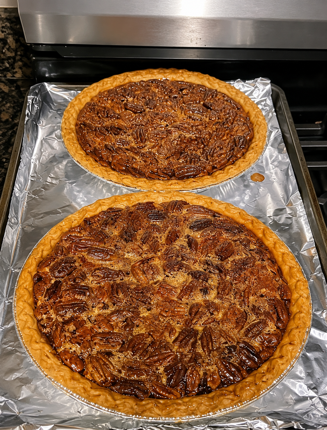 Classic pecan pie in a flaky deep-dish crust with glossy caramel filling, toasted pecan pieces, golden edges, and a rich buttery holiday dessert texture.