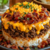 Bacon Cheeseburger Rice Stack made with seasoned ground beef, fluffy rice, melted sharp cheddar cheese, and crispy bacon, served as a layered comfort food dinner with a golden cheesy topping.