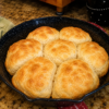 Old-Fashioned Appalachian Cathead Biscuits fresh from the oven with golden buttery tops, flaky layers, and soft, fluffy interiors. These giant Southern buttermilk biscuits are baked in a cast iron skillet and served warm with butter, honey, homemade jam, and sausage gravy for a classic Appalachian comfort food breakfast.